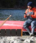 Person using 60W Portable Solar Panel Charger With PD3.0 USB C QC3.0 USB A And DC Output Foldable IP67 Waterproof Emergency Camping Power For Small Power Stations Grab And Go Phones Tablets And Power Banks on a canoe trip.