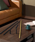 Black Tilted Aluminum Cabinet Handles 12 Pack 5 Inch 128mm on a coffee table next to a cup and book