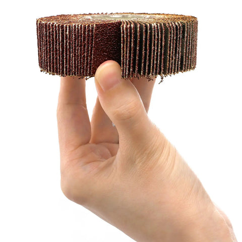 Hand holding a piece of a Twenty Piece Pro Grade Abrasive Flap Wheel Sander Set With Eight Flap Wheel Sizes And Two Cone Shapes, 80 Grit, One Quarter Inch Shank, Drill Ready For Metal And Wood, Rust Removal Made Easy showcasing the 80 grit surface.