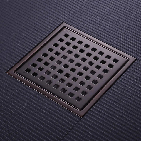 6 Inch Square Shower Floor Drain Brushed Bronze 304 Stainless Steel With Threaded Adapter Removable Grid Grate on textured surface.