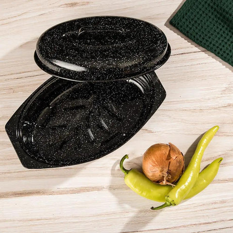 Oval 13 Inch Roaster With Lid Enameled Steel Pan That Holds Up To 7 Lb Poultry, black speckled design, with vegetables on the side.