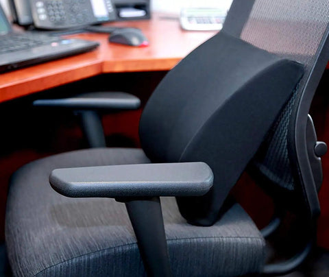 Premium Lumbar Support Pillow For Chair With Ergonomic Contoured Foam Insert designed to ease lower back pain on black office chair.