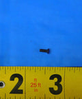 Top Shelf S-959 Indexable Insert Screw For Precision Metalworking With 2-56 By.25 Threads shown on ruler for size reference.