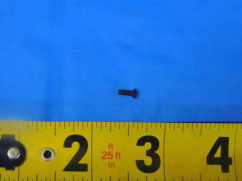 Top Shelf S-959 Indexable Insert Screw For Precision Metalworking With 2-56 By.25 Threads shown on ruler for size reference.