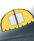 Dual Airbag Wing Foil Kitesurfing Trainer Kite With Window Design And Safety Window Panel in yellow over ocean wave.