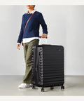 Front view of Amazon Basics 30-inch black hardside luggage with four multi-directional wheels