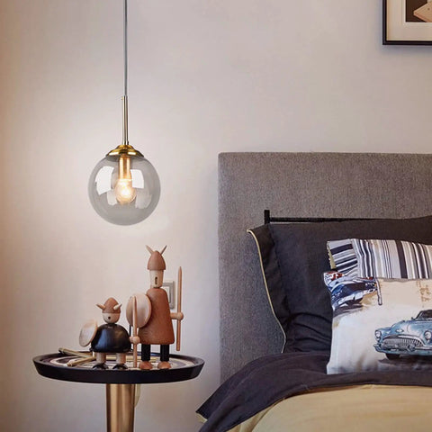 Three Light Pendant Light Fixtures with Brass Lamp Holder and Handblown Glass Shade, 5.9 Inch Globe Shade, in a bedroom setting