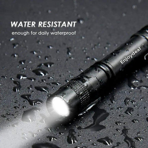 Ultra Slim 1000 Lumen Pen Light Flashlight With Clip Pocket LED Aluminum Body Powered By Two AAA Batteries Not Included Long Lasting EDC Tool For Home Work Auto Outdoors, water-resistant black flashlight with light beam on wet surface.