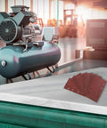 Awesome 80-Piece Premium Sanding Sheets With Durable Grit Assortment For Wood And Metal Projects on a workbench with compressor.