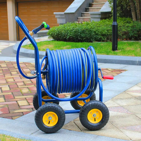 Heavy Duty Garden Hose Reel Cart With Smooth Gliding Wheels And Tangle Free Routing For Zero Sweat Gardening Plus Adjustable Metal Spray Gun on patio.