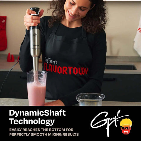 Woman using Pretty Dang Powerful Immersion Blender With 400W DynamicShaft Tech to blend a pink smoothie in a cup.