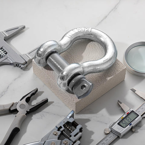 Single shackle from 4 Pack 1 Inch D Ring Shackles Bow Shackle With One And One Eighth Screw Pin Beefy Heavy Duty Tow Rigging Lifting Recovery Kit 8.5 Tons Working Load Limit Built For Winch Tow Moving with tools on a marble surface