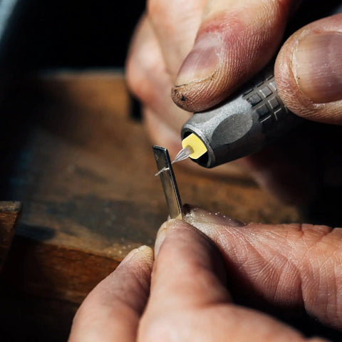 Close-up of hands using Dope Carbide Micro Drill Bits Set For Jewelry Making And PCB Engraving on metal surface
