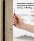 Person holding 4 Pack 7.87 Inch Black Barn Door Handles Built To Last Heavy Duty Rustic Metal Cabinet Pulls on wooden door.