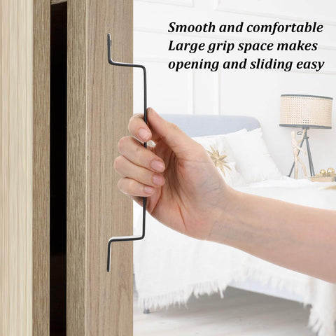 Person holding 4 Pack 7.87 Inch Black Barn Door Handles Built To Last Heavy Duty Rustic Metal Cabinet Pulls on wooden door.