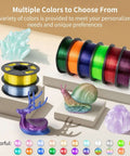 Multiple colored spools of filament and printed models displayed, showcasing Crystal Clear PETG Filament 1.75mm 1kg for 3D printing.