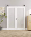 52 Inch By 80 Inch Frosted Glass Bifold Barn Door Kit With 64 Inch Track in white MDF, installed as a sliding closet door.