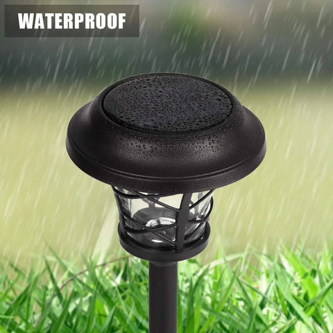 Close-up of a Six Pack Solar Pathway Light Outdoor Waterproof Garden Light with metal and glass under rain, on grass.