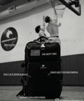 Elite 45L Tactical Backpack For Work And Missions in a gym, showing padded straps and MOLLE system, Carbon Black.