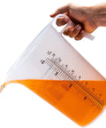 One Gallon 128oz Pitcher With Handy Conversion Chart Built Tough Food Grade Plastic BPA Free Translucent See Through Gripper Handle pouring liquid
