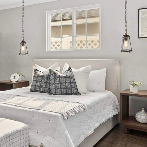 Modern Farmhouse Pendant Light For Kitchen Island In Bronze Finish With Seeded Glass Shade illuminating bedroom.