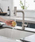 Slick Hands Free Kitchen Sink Faucet With Pull Down Sprayer And Waterfall Flow featuring 360 Degree swivel design rinsing an apple.