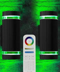 Outdoor Up And Down Wall Light With Lit RGB Color Changing LEDs 12W 1200 Lumens White 2700K To 6500K Nine Modes RGB CCT ETL Listed Exterior Lighting Pack Of 2 shown with remote control, green light effect on brick wall.