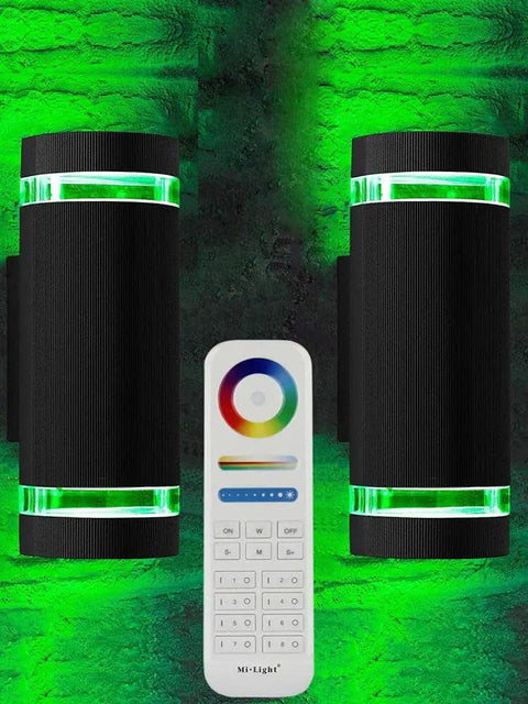 Outdoor Up And Down Wall Light With Lit RGB Color Changing LEDs 12W 1200 Lumens White 2700K To 6500K Nine Modes RGB CCT ETL Listed Exterior Lighting Pack Of 2 shown with remote control, green light effect on brick wall.