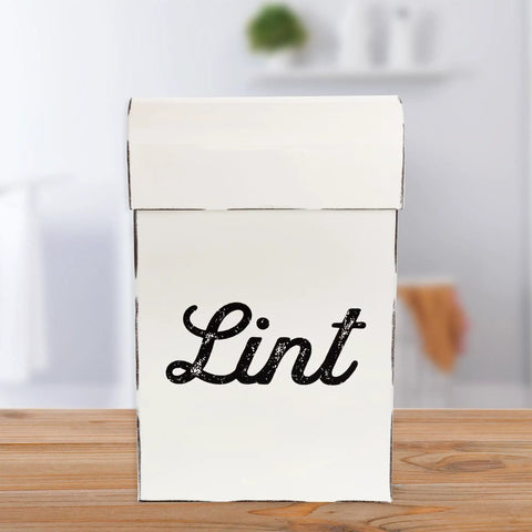 Front view of Vintage Shabby Chic Enamel Lint Bin With Magnetic Back, Retro Farmhouse Style, sitting on wooden counter.