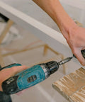 DIY Wood Screws Assortment Kit With 480 Pieces M3 And M4 Black Self Tapping Fasteners being used on a cabinet hinge