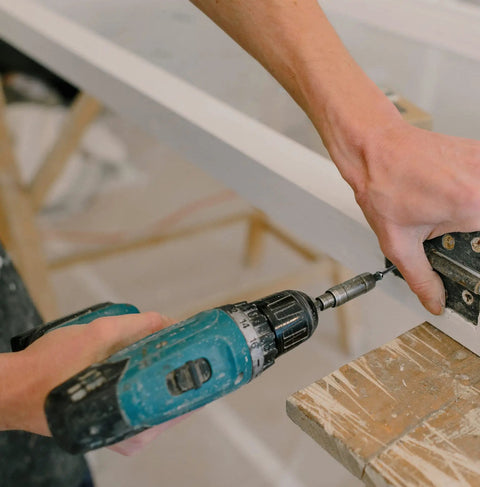 Person using a drill to install the Wood Screws Kit 300 Pcs Six Sizes Flat Head Phillips Drive Self Tapping Coarse Thread Screws