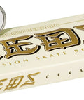 Bones Ceramic Reds skateboard bearings, 8-pack, with two bearings resting on a cream Bones box.