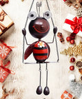 Solar Powered Ladybug Swing Garden Decor Waterproof Metal Hanging Lights for outdoor patio with festive background.