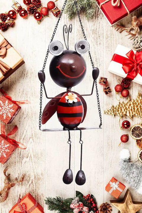Solar Powered Ladybug Swing Garden Decor Waterproof Metal Hanging Lights for outdoor patio with festive background.
