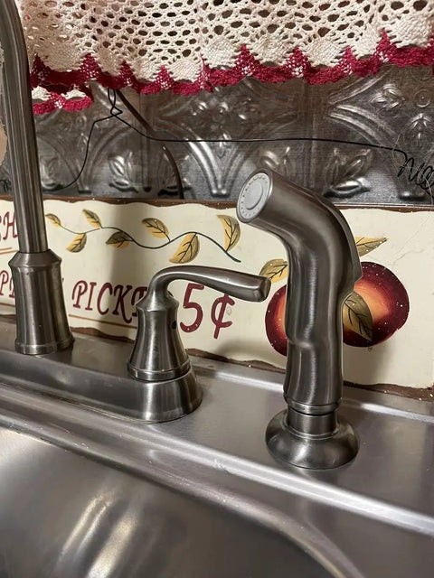 Universal Kitchen Sink Spray Attachment Pull Out Faucet Sprayer Head Brushed Nickel Finish on kitchen sink with decorative backdrop.