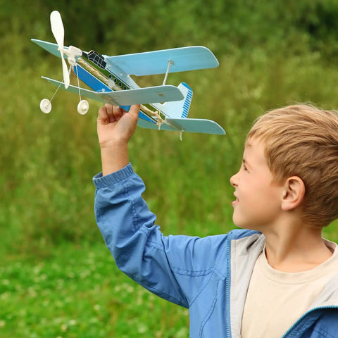 Child holding a model airplane in a park, showcasing the use of Metal Clevis Quick Link M2 Thread Steel Clevis.