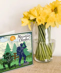 Must Have Mountain Camping Climbers Cutting Dies Set For Card Making And Scrapbooking shown with daffodils in a vase.