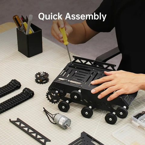 Person assembling Beefy All Metal Tank Chassis With DC Geared Motor And Shock Absorbing Suspension For A Full Track Robotic Moving Platform