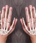 Person holding Six Pack Halloween Skeleton Hands Set Realistic Plastic Skeleton Hands for Spooky Decor Right and Left Hands