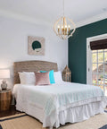 Modern Farmhouse 4 Light Wood Chandelier In Distressed White And Gold With Orb Globe Cage Pendant Lighting For Dining Room Kitchen Island And Foyer For Any Space over a bright bedroom with teal accents