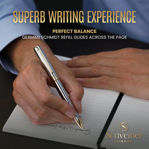 Person writing with Luxurious Silver Chrome Ballpoint Pen With Real Gold Plating And Schmidt Black Refill on a notepad.