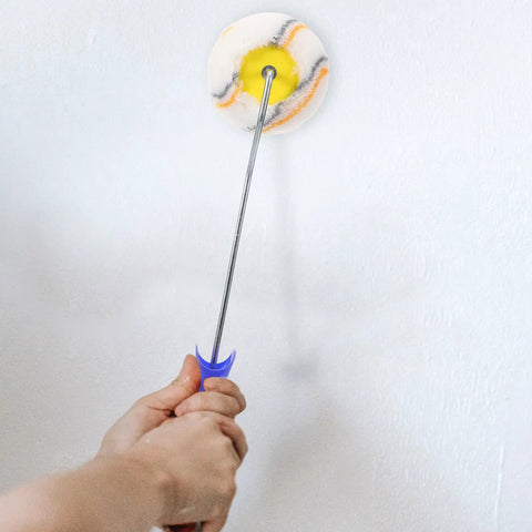 Slick Paint Roller Brush And Corner Edger For Snug Corners Window Trim And Door Frames used for painting a wall.