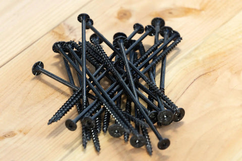 Heavy Duty Exterior Wood Screws With Aggressive Sawtooth Tip That Slides Right Into Lumber For No Sweat Install And Smooth Flush Heads With Ridiculous Grip On Your Next Deck Upgrade Pack Of Twelve Tan stacked on wood surface.