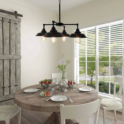 Four Light Black Kitchen Island Pendant Light with dope industrial farmhouse style in dining room above round table.