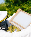 Beekeeper holding Solar Fume Board For Beehives, Universal 8 Frame And 10 Frame Inner Cover with metal top outdoors