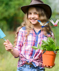 Young girl with hat holding potted plant with Dope Dragonfly Clip 12 Pack For Garden Decor And Outdoor Stakes DIY Fake Dragonfly Clips