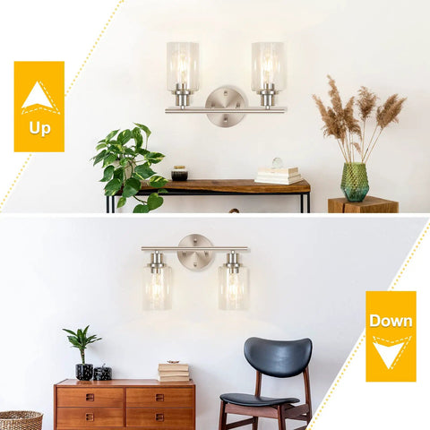 2 Light Wall Sconce Vanity Light In Brushed Nickel With Clear Glass Shades, shown facing up and down in living spaces.