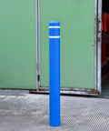 Tough As Nails Blue Safety Bollard Cover 6 Inch Wide 46 Inch Tall with reflective tape in a parking lot setting.