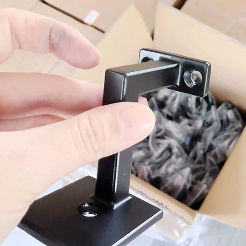 Close-up of 3-3/8 inch high swivel handrail bracket in hand, textured black finish, for staircases built tough with screws.