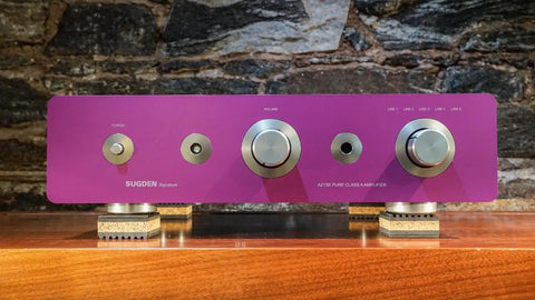 Purple audio amplifier on cork isolation pads, highlighting front knobs and control panel, cork isolation pads for turntables, 1 inch thick, pack of 4